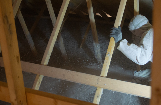 A residential building envelope with insulation visible during construction
