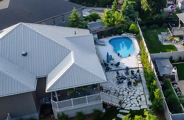 A designed backyard outdoor living space with greenery and seating
